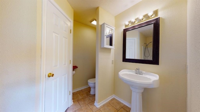 bathroom with sink, tile patterned flooring, and toilet