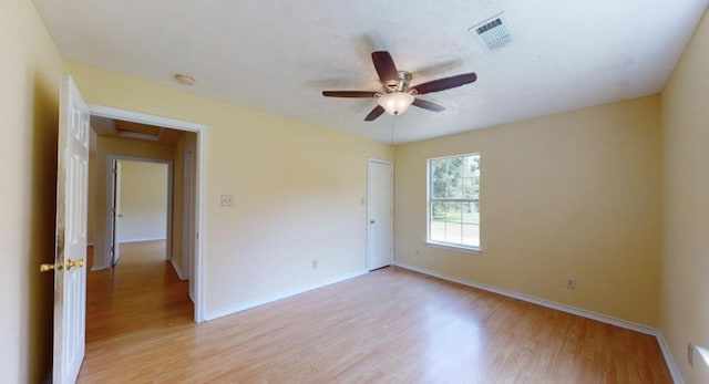 empty room featuring ceiling fan and light wood-type flooring