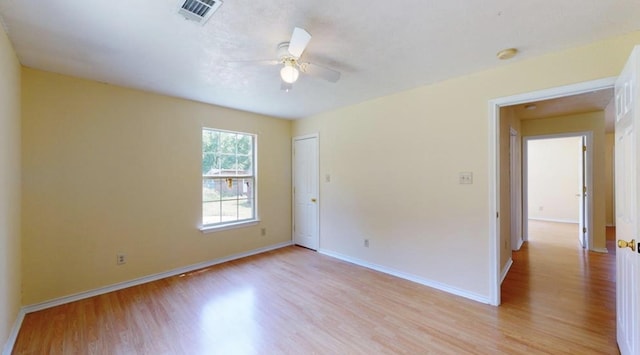 spare room with ceiling fan and light hardwood / wood-style floors