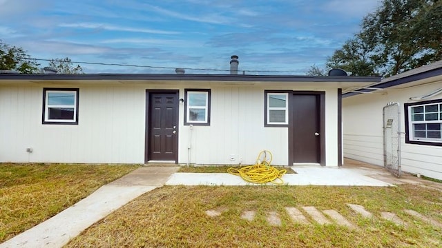 doorway to property featuring a yard