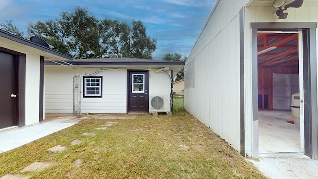 exterior space with a lawn and ac unit