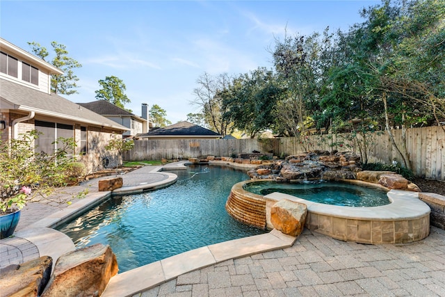 view of swimming pool featuring an in ground hot tub and pool water feature