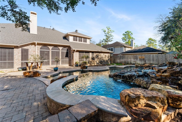 view of swimming pool with a patio area and pool water feature