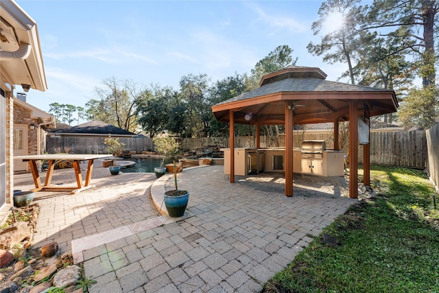 view of patio featuring a gazebo, area for grilling, a fenced in pool, and grilling area