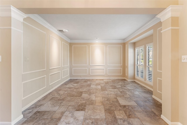 empty room featuring ornamental molding and decorative columns