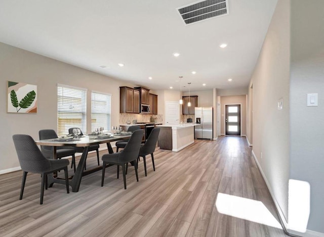 dining area with light wood-type flooring