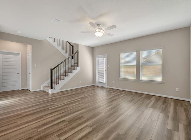 unfurnished living room featuring ceiling fan and hardwood / wood-style floors