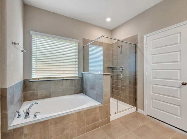 bathroom featuring tile patterned flooring and plus walk in shower