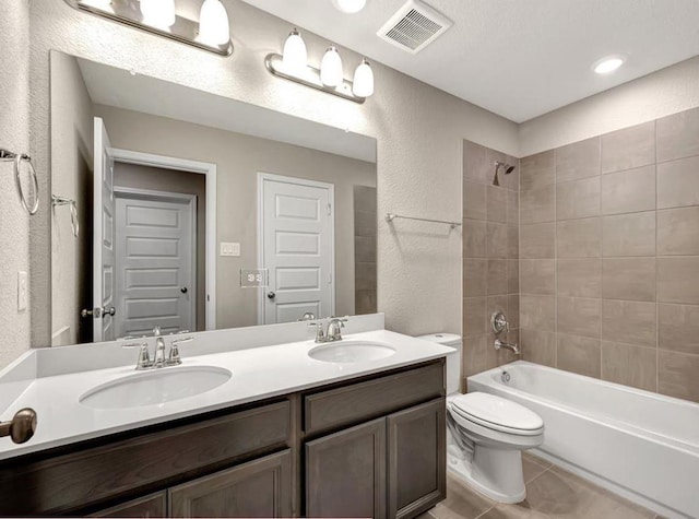 full bathroom with tile patterned flooring, vanity, toilet, and tiled shower / bath