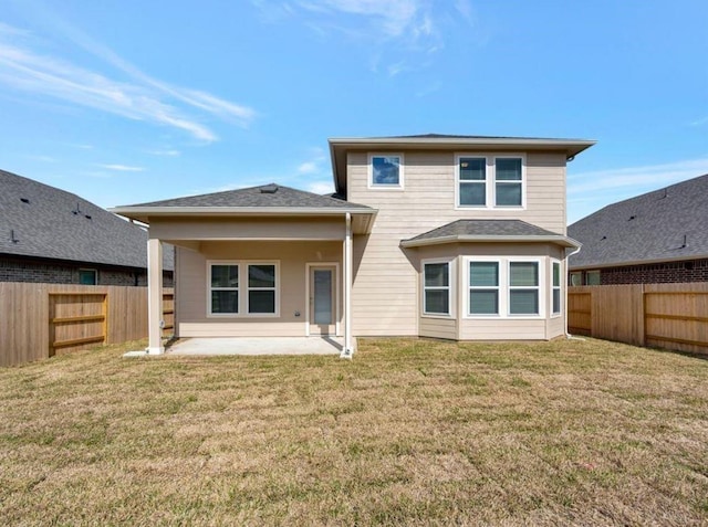 rear view of house with a yard and a patio