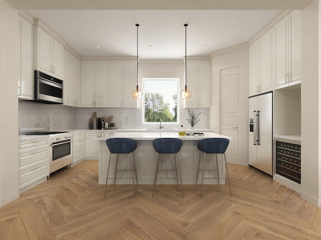 kitchen featuring white cabinets, premium appliances, a kitchen island, and a breakfast bar area