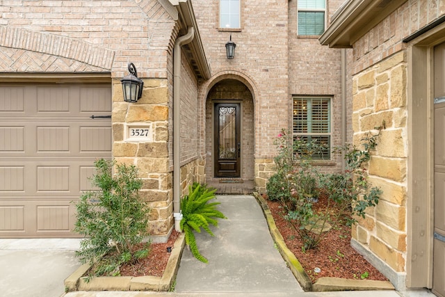 view of exterior entry with a garage