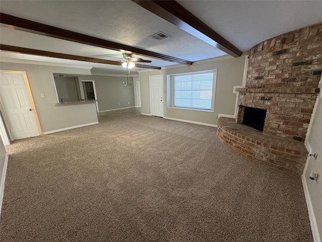 unfurnished living room with carpet, ceiling fan, beam ceiling, and a brick fireplace