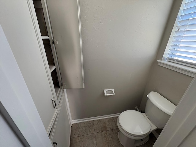 bathroom with tile patterned flooring and toilet