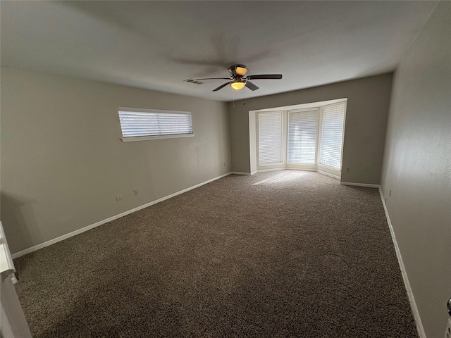 carpeted empty room featuring ceiling fan