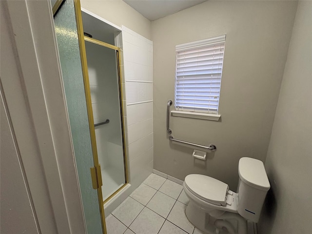 bathroom with tile patterned floors, toilet, and walk in shower