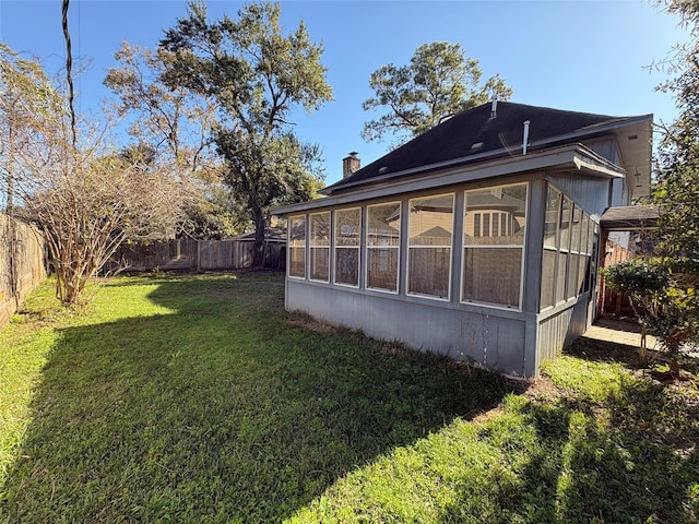 exterior space featuring a yard and a sunroom