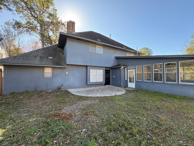 back of house with a patio area, a sunroom, and a yard