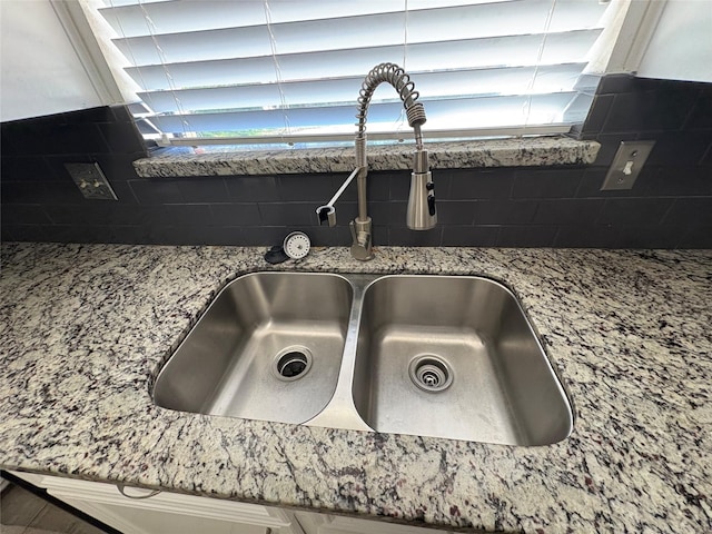 details with stone counters, backsplash, and sink