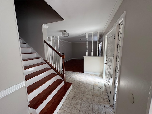 stairway featuring crown molding