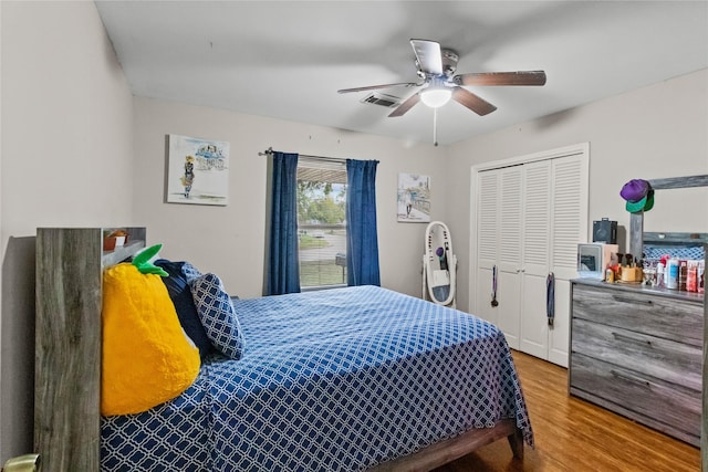 bedroom featuring hardwood / wood-style floors, a closet, and ceiling fan