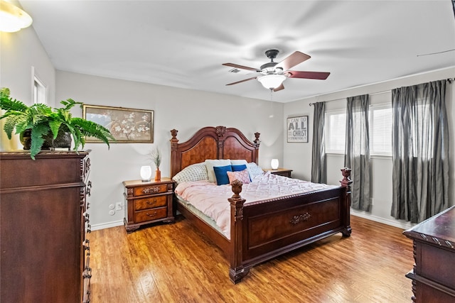 bedroom with ceiling fan and light hardwood / wood-style floors