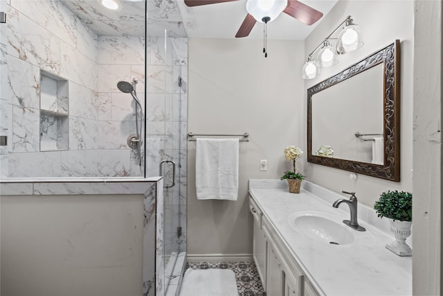 bathroom with ceiling fan, a shower with shower door, and vanity