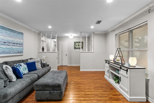 living room with crown molding and hardwood / wood-style floors