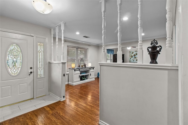 entryway featuring crown molding and hardwood / wood-style floors