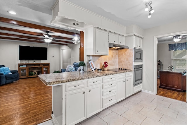 kitchen with kitchen peninsula, stainless steel appliances, light tile patterned floors, backsplash, and white cabinets