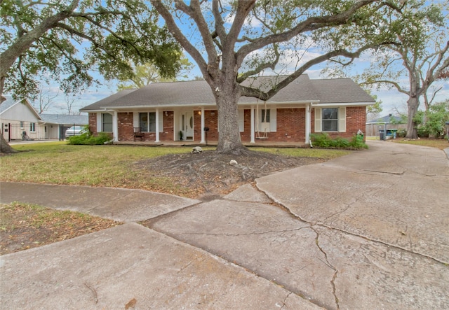 ranch-style home featuring a porch and a front lawn