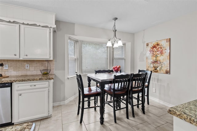 tiled dining room with a chandelier