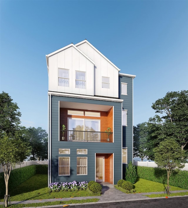 view of front of property with a balcony and a front yard