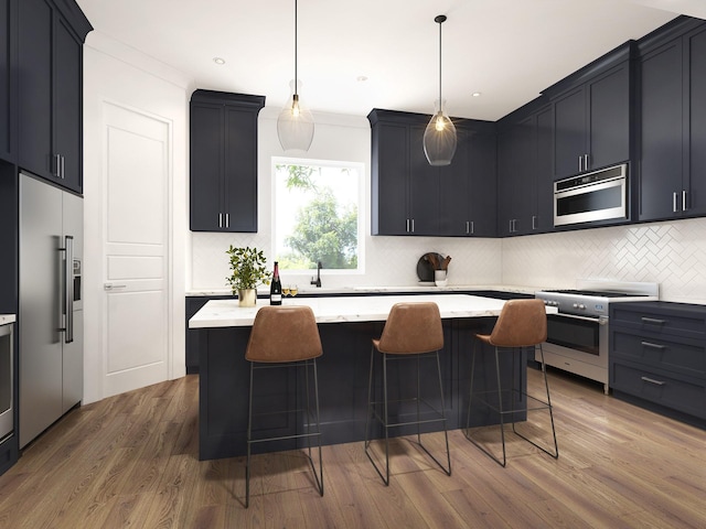 kitchen with tasteful backsplash, a kitchen island, a breakfast bar, wood finished floors, and high end appliances