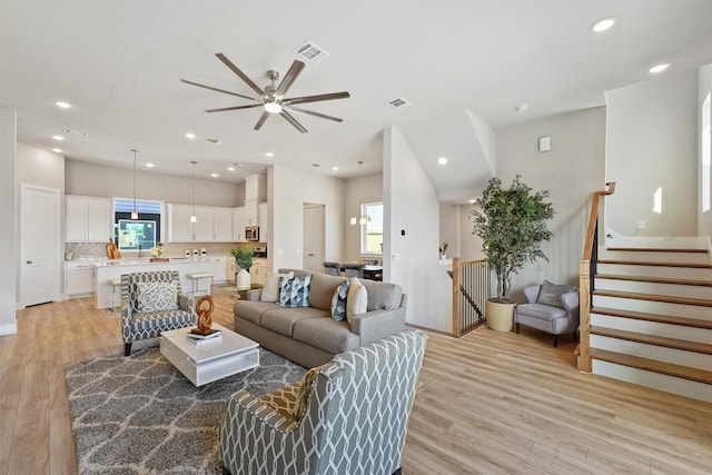 1956 Purswell Rd, Houston, TX 77055 - living area with light wood-style floors, a ceiling fan, recessed lighting, and stairway