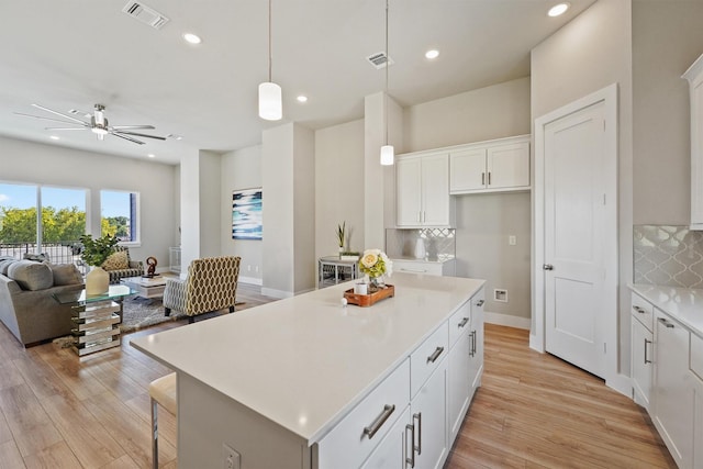 1956 Purswell Rd, Houston, TX 77055 - kitchen with open floor plan, tasteful backsplash, a kitchen island, light countertops, and recessed lighting