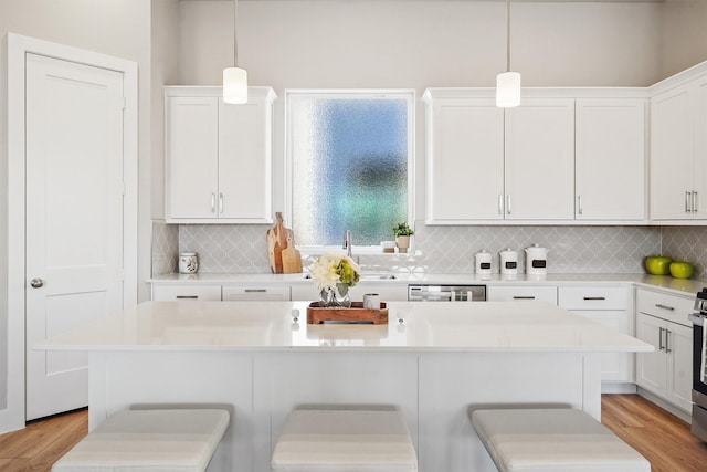 1956 Purswell Rd, Houston, TX 77055 - kitchen featuring a kitchen bar, white cabinetry, and light countertops
