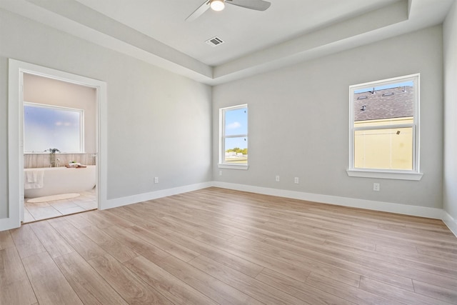 1956 Purswell Rd, Houston, TX 77055 - unfurnished room with light wood finished floors, a ceiling fan, a tray ceiling, and baseboards