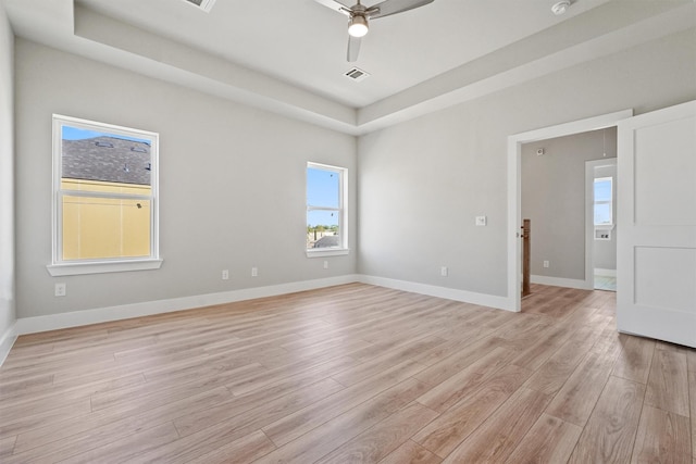 1956 Purswell Rd, Houston, TX 77055 - spare room featuring light wood-type flooring, a tray ceiling, ceiling fan, and healthy amount of natural light