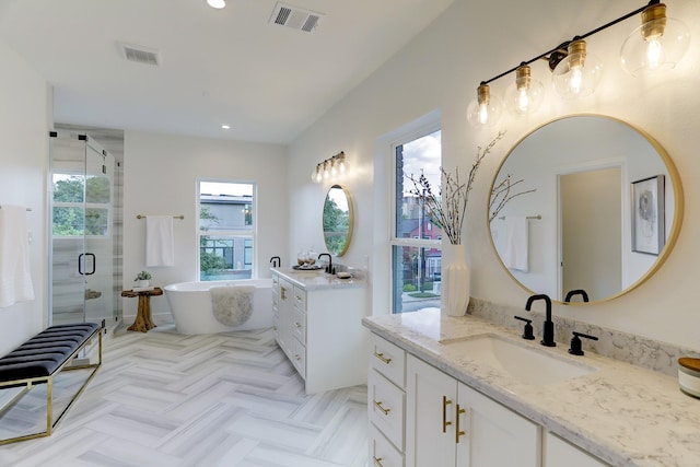 bathroom with separate shower and tub, a wealth of natural light, and vanity