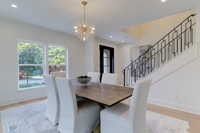 dining space with a chandelier and light wood-type flooring