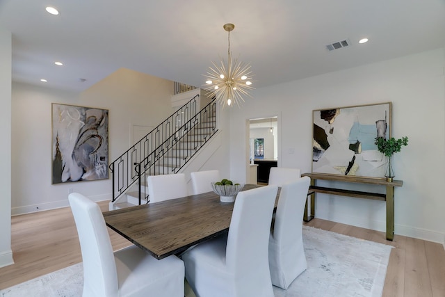 dining room with a chandelier and light wood-type flooring