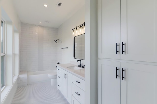 full bathroom with tile patterned flooring, vanity, toilet, and tiled shower / bath