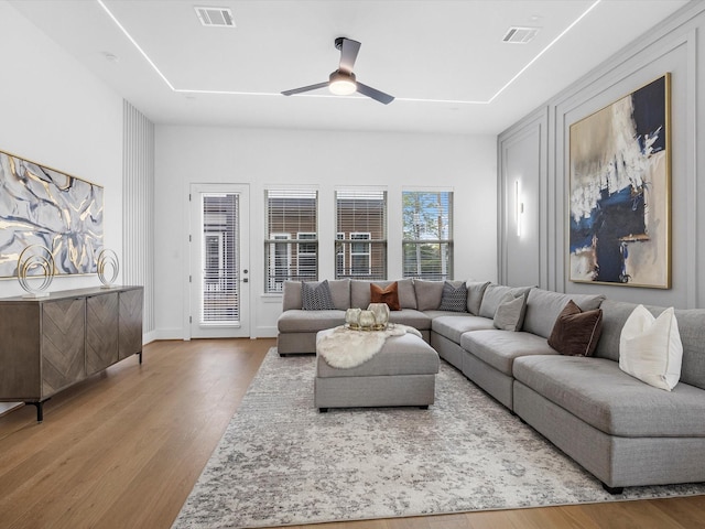 living room featuring ceiling fan and hardwood / wood-style floors