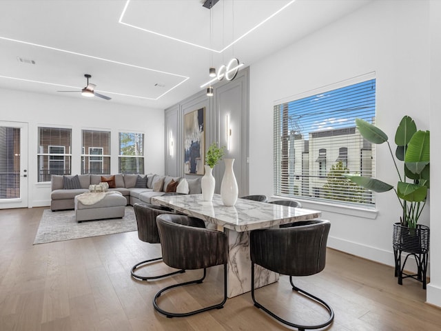 dining area with hardwood / wood-style flooring and ceiling fan