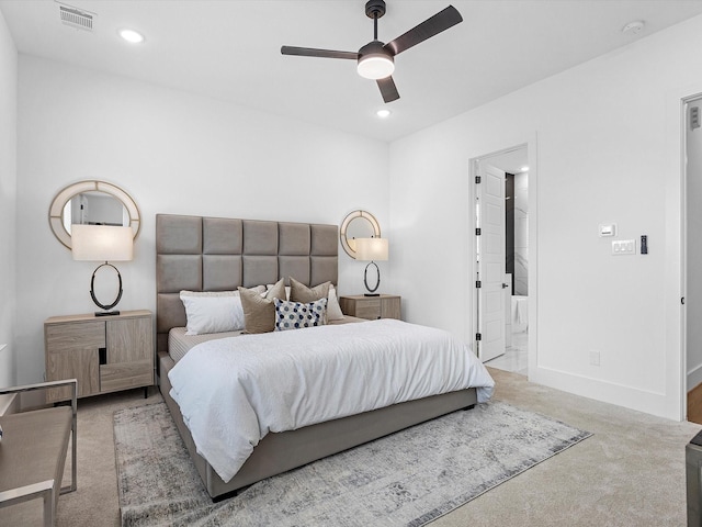 carpeted bedroom featuring ensuite bath and ceiling fan