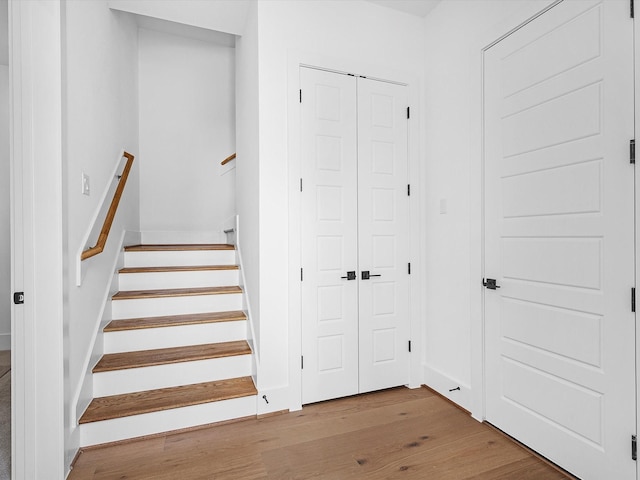 staircase with hardwood / wood-style floors