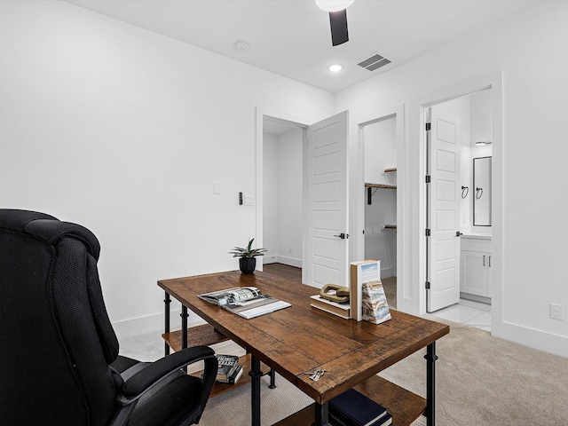 carpeted office featuring ceiling fan