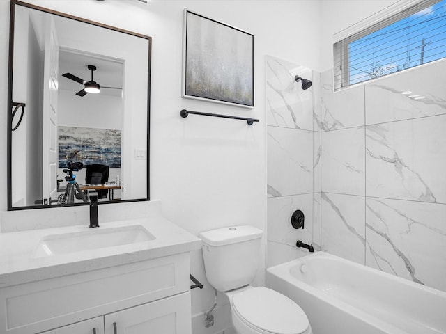 full bathroom with vanity, ceiling fan, toilet, and tiled shower / bath combo