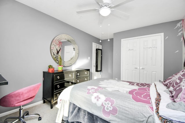 carpeted bedroom with ceiling fan and a closet